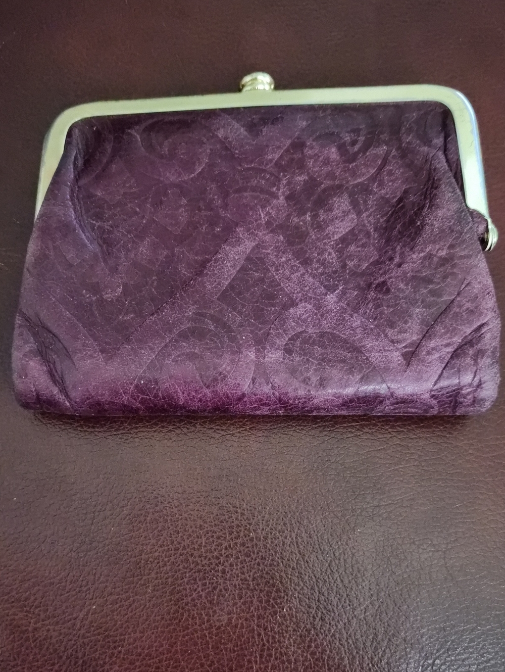 This Hobo wallet features a purple leather construction.